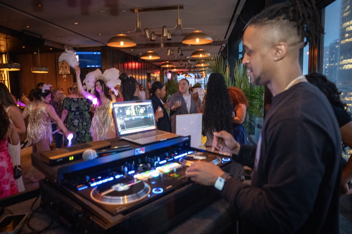 DJ Takeova performing at a lounge DJ setup