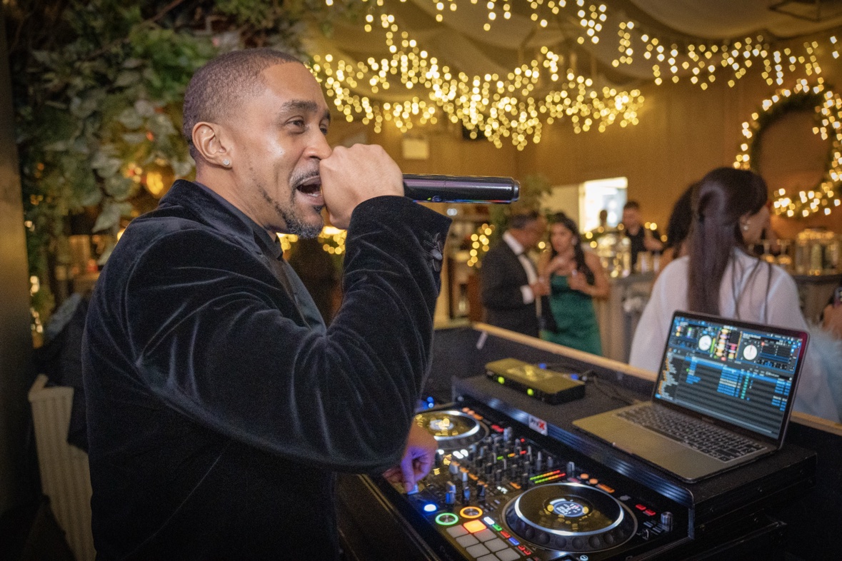 DJ Takeova performing at a wedding celebration